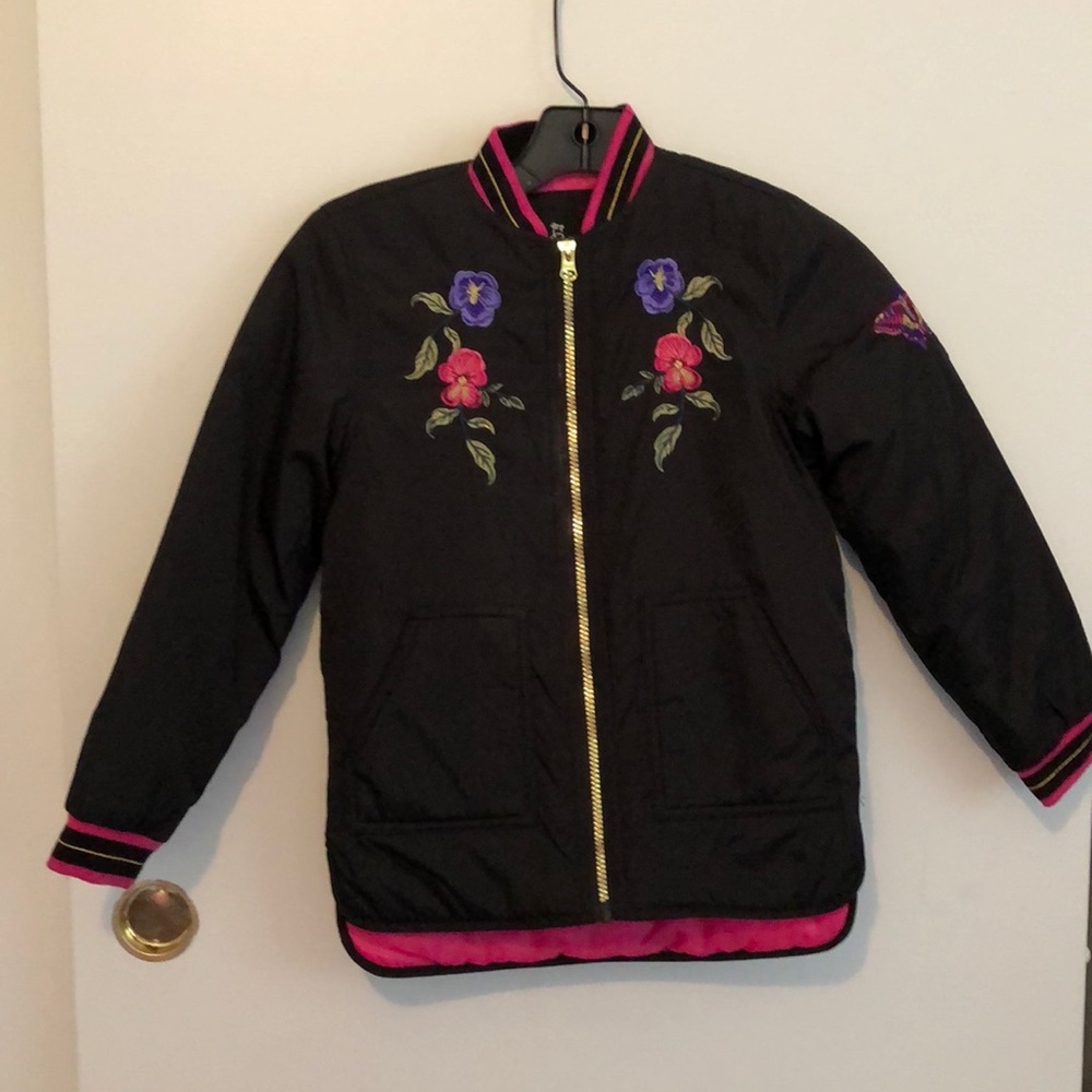 black puffy jacket with floral embellishments